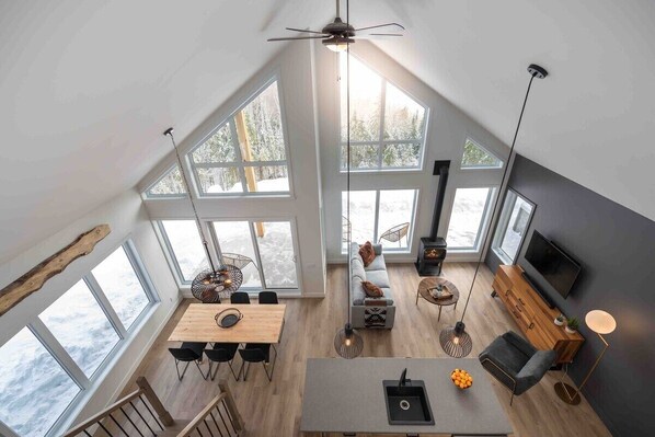 Sun-drenched living area, huge windows, breathtaking views.