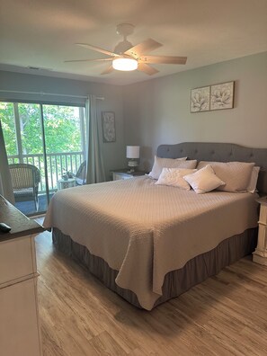 Master king bedroom with master bath and slider to patio and water view
