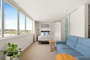 Spread out in comfort in the queen-sized bed, alongside sweeping window vistas of the coastline.