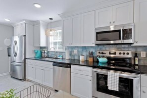 This stunning full kitchen boasts top-of-the-line appliances and luxurious finishes like dishwasher, fridge, granite countertops, oven stove, and microwave oven, making it a dream space for any home cook.  Ample storage with spacious drawers keeps your kitchen organized and clutter-free.  This well-equipped and stylish space is perfect for whipping up delicious meals and entertaining loved ones.