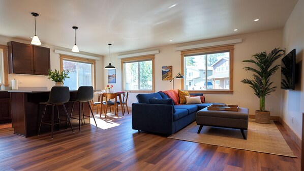 Open plan main space. Bright and sunny. Top down blinds on the large windows.