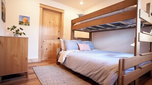 2nd bedroom with twin xl-over-queen bunk bed and walk in closet.
