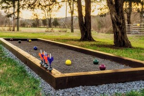 Amidst the tranquility of our vacation rental's backyard lies the stage for a timeless game of bocce. Its simple rules and strategic depth make it a perennial favorite for outdoor gatherings and social events.