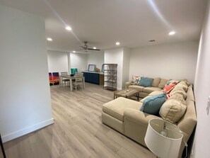 Upstairs game room with large sectional for extra sleeping space and blow up bed