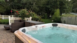 Hot tub is available year round and located to the side of the house. Also has nearby outdoor seating area with cushions in storage bin.