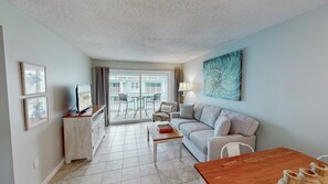 The cozy living room is adorned with a brand-new plush sofa, perfect for enjoying your favorite shows on the smart TV.