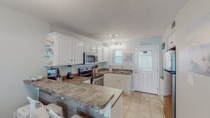 Upon entering the condo, you are in the heart of the home where culinary adventures await. The well-stocked kitchen has everything you need to prepare your favorite meals just as if you were at home.