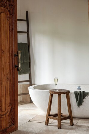 Main ensuite complete with stone bath and overhead shower