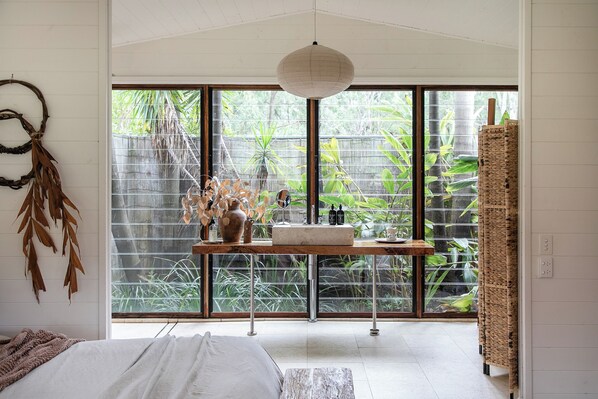 The boathouse bathroom opens into a private rainforest garden