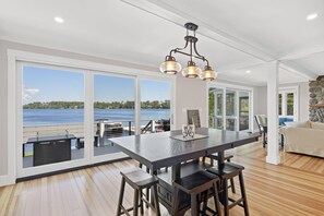 Dining area with expansive lake views (table can be extended) you can also see the built in seating around the propane fire pit on the deck