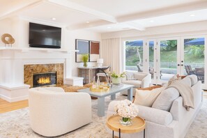 Relax in our living room with plush seating, a flat-screen TV, and a warm fireplace.