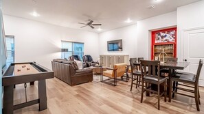 Cozy living room with a comfy sofa, modern decor, and natural light, just minutes from Arlington's stadiums and entertainment district.