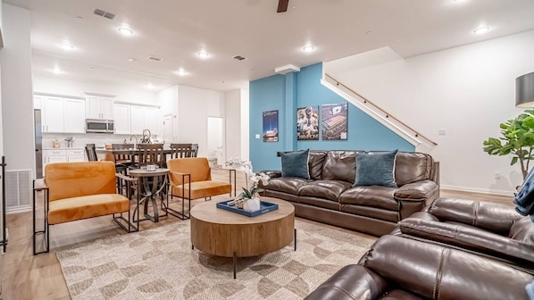 Cozy living room with a comfy sofa, modern decor, and natural light, just minutes from Arlington's stadiums and entertainment district.