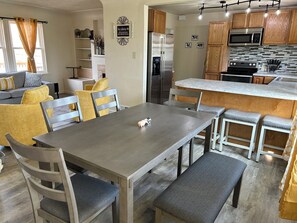 Kitchen table has room to seat 6 and 4 more can sit at the bar.