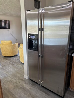 Stainless steel fridge with working water filter and ice maker.