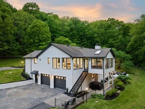 Exterior of house perfectly nestled in a lush wooded area