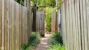 Gate at end of pathway to Enter Secret Courtyard