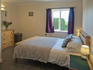 Double bed, blanket and matching cushions, chest of drawers, bedside table and lamp