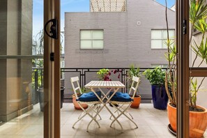 Enjoy your morning brew out on the balcony amongst fresh air and sunshine where you will find a charming table and chairs surrounded by green pot plants. 
