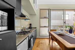 The dining area adjoins the kitchen and living room, creating an easygoing social flow throughout the home. 
