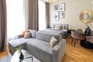 Living area with a bed, sofa bed and kitchen