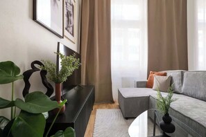 Living area with a bed, sofa bed and kitchen