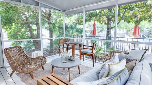 Large screened-in porch overlooking the pool. Best spot for morning coffee.