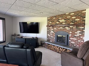 Living room area with propane fireplace.