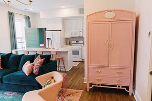Spacious open concept living room/kitchen with island & 4 bar stools, 75" TV.