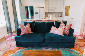 Spacious open concept living room/kitchen with island & 4 bar stools, 75" TV.