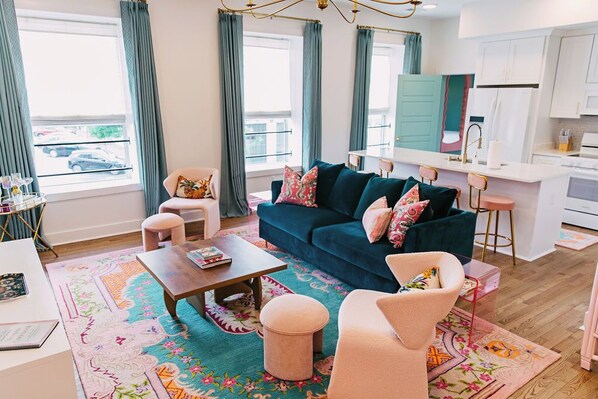 Spacious open concept living room/kitchen with island & 4 bar stools, 75" TV.