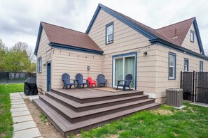 Spacious deck with outdoor tables and chairs. 