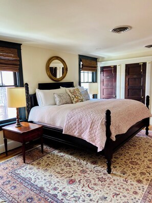 King sized elevated bed in back of apt with sitting area and sun porch attached