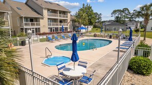 Enjoy the inviting pool surrounded by comfortable sun chairs and a relaxing hot tub—your perfect spot for soaking up the sun or unwinding in style.