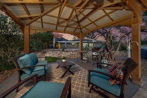 Spacious backyard's lovely ramada with comfortable seating and grill
