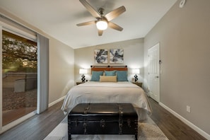 Primary bedroom with king bed, walk-in closet, and en-suite bathroom