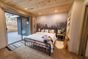 The first bedroom can sleep up to 2 adults and has a queen bed and ensuite jack & jill bath. This bedroom also has sliding door access to the gated back deck and hot tub. The bed features Brooklinen® crisp white hotel-style luxury bedding. 