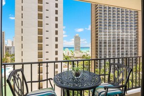 Enjoy coffee on your balcony with an ocean and pool view.