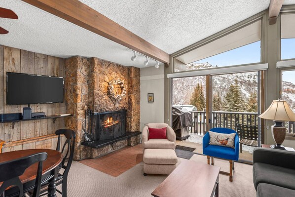 Enjoy the cozy fireplace with snow capped peaks from your top floor unit!