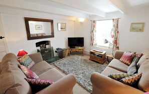 Sitting room with sofas, tv, fireplace