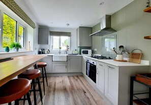 Kitchen with breakfast bar and three stools