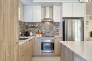 Open Plan kitchen with fridge, dishwasher, microwave, Oven, Stove