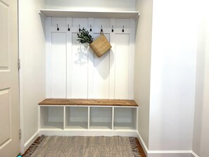 Welcome to our home. Settle in with custom cabinetry and built-in coat racks.