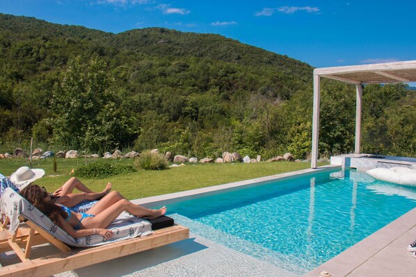 Relax by the private pool of the villa