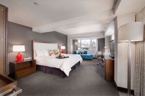 Spacious and inviting bedroom with a comfortable bed and elegant sitting area, perfect for relaxation and leisure.