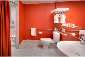 Refreshingly modern accessible bathroom with bright walls and contemporary amenities, offering a vibrant start to your day.