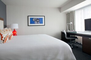 Unwind in this serene, minimalist bedroom with plush bedding and a tranquil atmosphere, designed to ensure a restorative night's sleep.