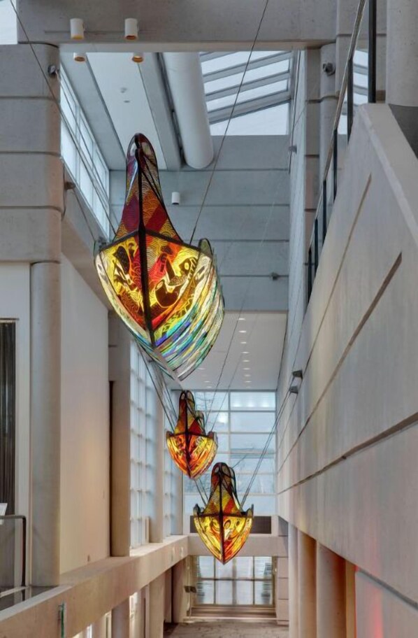 A captivating display of glass art suspended in the hotel's corridor, adding a splash of color and artistic flair to the modern architecture.