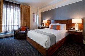 Spacious King room designed for ultimate comfort and convenience, complete with a plush bed and a well-equipped work area.