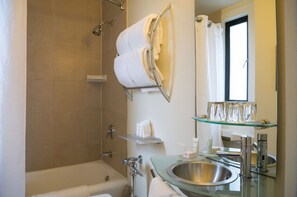 Elegant bathroom with classic fixtures and a large mirror, providing a bright space for rejuvenation.